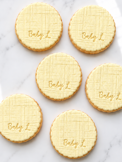 Scalloped baby, linen texture initial fondant cookies